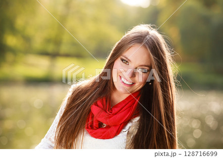 Portrait girl relaxing walking in autumnal park. 128716699