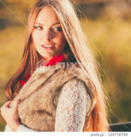 Portrait girl relaxing walking in autumnal park. 128716700