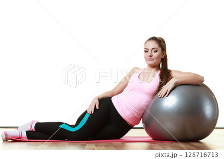 woman doing fitness exercise with fit ball woman doing fitness exercise with fit ball 128716713