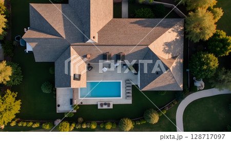 Elegant Aerial View of Modern House with Pool Surrounded by Lush Greenery and Landscape 128717097