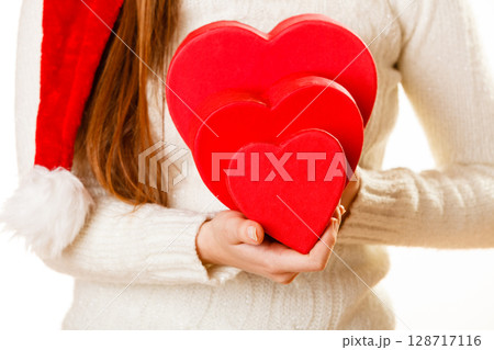 Girl holding cute hearts. 128717116