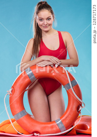 Lifeguard woman on duty with ring buoy lifebuoy. 128717173