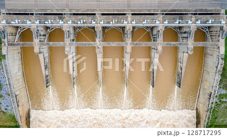 Aerial drone view of hydroelectric dam with flowing water 128717295