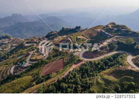 Aerial view of curvy road with hillside resorts up to Phu Tub Berk in Phetchabun, Thailand Aerial view of curvy road with hillside resorts up to Phu Tub Berk in Phetchabun, Thailand 128717311
