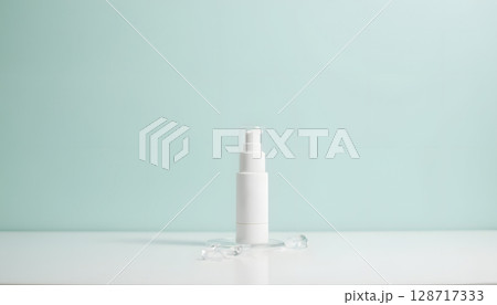 Minimalistic White Skincare Bottle on Smooth Surface with Soft Mint Background for Beauty Products 128717333