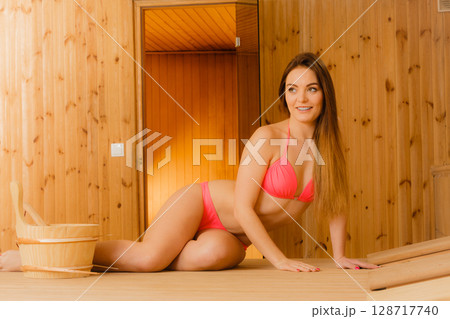 Young woman relaxing in sauna. Spa wellbeing. 128717740