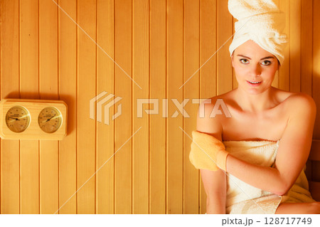 woman relaxing in wooden sauna room 128717749