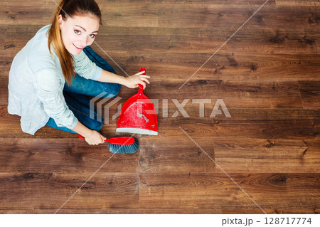 Cleaning woman sweeping wooden floor Cleaning woman sweeping wooden floor 128717774