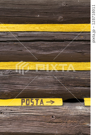 Yellow stripes indicating the direction of the post office in Osturna, Slovakia Yellow stripes indicating the direction of the post office in Osturna, Slovakia 128718011