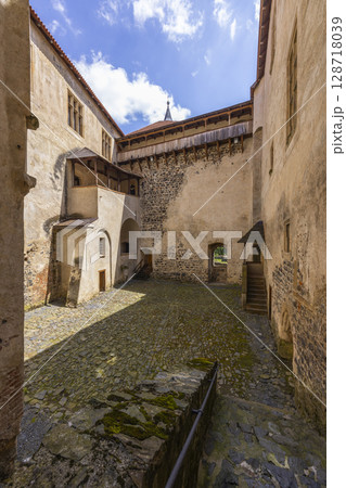 Svihov water castle courtyard showing walls, tower, and wooden walkway in Czechia 128718039
