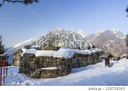 Ruins of Fort Hensel in Tarvisio covered by snow during winter with Julian Alps in background Ruins of Fort Hensel in Tarvisio covered by snow during winter with Julian Alps in background 128718163