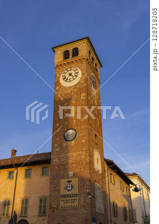 Clock tower standing tall in Cherasco, Piedmont, Italy 128718205