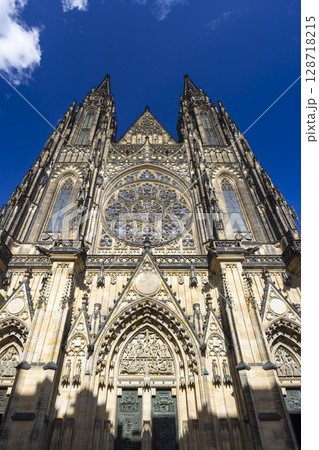 St. Vitus Cathedral rising majestically against a vibrant blue sky in Prague 128718215