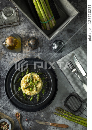 Gourmet Risotto Dish with Fresh Asparagus Garnish 128718231