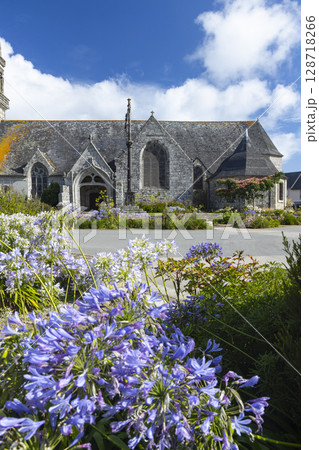 Historic Church in Poullan sur Mer with Blooming Flowers Historic Church in Poullan sur Mer with Blooming Flowers 128718266