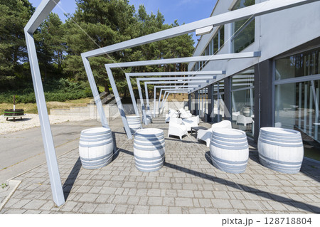 Outdoor seating area with decorative barrels and pergola providing shade in Velky Krtis, Slovakia 128718804