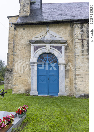 Blue door of Church of Ourdis Cotdoussan during rainy day in Occitanie, France Blue door of Church of Ourdis Cotdoussan during rainy day in Occitanie, France 128718929