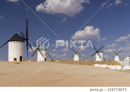 Traditional windmills standing on a hill in Campo de Criptana, Spain Traditional windmills standing on a hill in Campo de Criptana, Spain 128719073