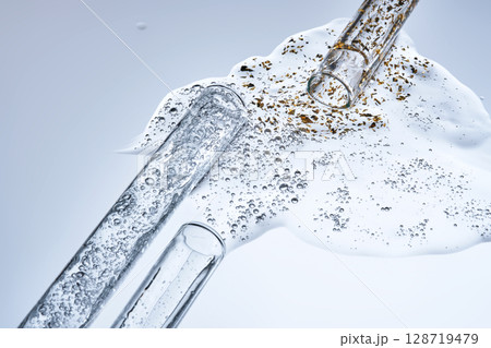 Three test tubes with spilled serums. Demonstration of textures. 128719479