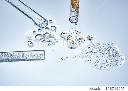 Three test tubes with spilled serums. Demonstration of textures. 128719495