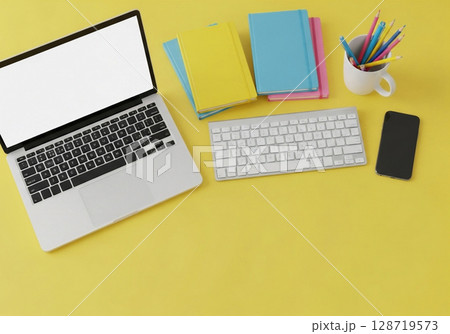 office desk table with laptop, smartphone and othe 128719573