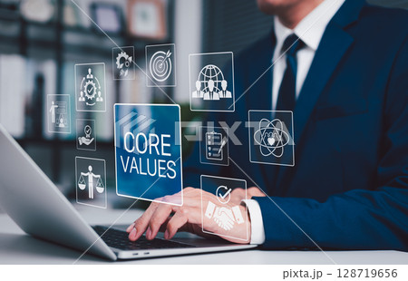 Business Core Values and Corporate Culture Concept. Businessman working on laptop with core values icons, ethics, teamwork, integrity, corporate mission, organizational culture and business principles Business Core Values and Corporate Culture Concept. Businessman working on laptop with core values icons, ethics, teamwork, integrity, corporate mission, organizational culture and business principles 128719656