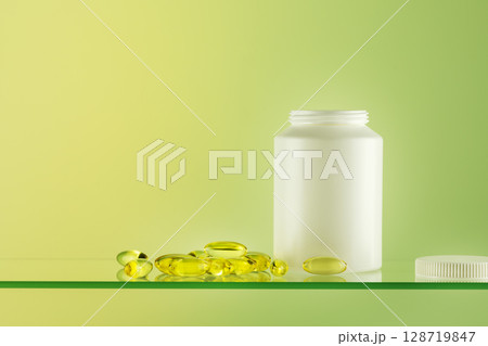 Mockup of natural bio pills, vitamins or supplements on gradient background with copy space. White bottle with healthy supplements in gel capsules. Omega 3. Organic vitamins and nutrients. Front view 128719847