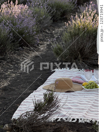 Lavender Field Picnic with Straw Hat and Grapes Lavender Field Picnic with Straw Hat and Grapes 128719941