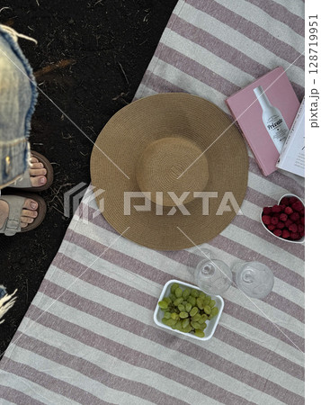 Summer Picnic Setup with Straw Hat and Fresh Fruit Summer Picnic Setup with Straw Hat and Fresh Fruit 128719951