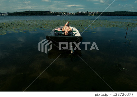 The girl gently holds her dress 128720377