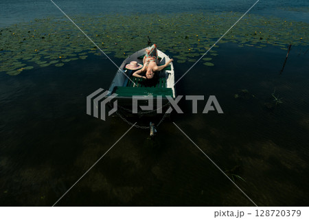 The girl gently holds her dress 128720379