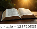 An open book on a wooden table under warm light. Image created by artificial intelligence 128720535
