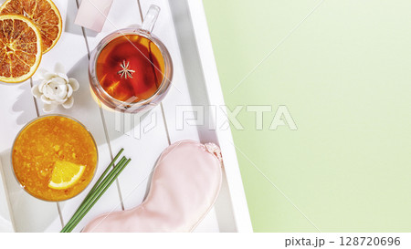 Sleep care banner with mask for sleep, cup of tea, orange jam, aroma sticks on wooden tray with copy space. Concept of relax, self care and me time. Insomnia or depression treatment, sleepless nights Sleep care banner with mask for sleep, cup of tea, orange jam, aroma sticks on wooden tray with copy space. Concept of relax, self care and me time. Insomnia or depression treatment, sleepless nights 128720696