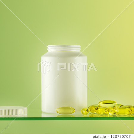 Mockup of natural bio pills, vitamins or supplements on gradient background. White bottle with healthy supplements in gel capsules. Omega 3. Organic vitamins and nutrients. Front view 128720707