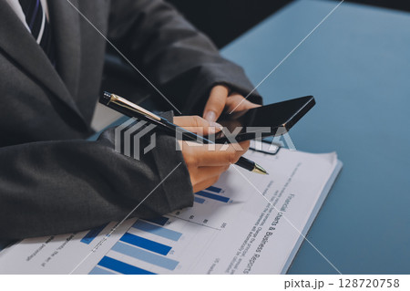 Asian business man using cell phone. Having Conversation, typing sms or presenting. Asian business man using cell phone. Having Conversation, typing sms or presenting. 128720758