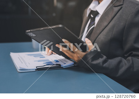 Accounting company provide finance and taxation planning for profitable cash flow, Auditor and accountant team working in office, analyze financial data and accounting record with calculator.Insight Accounting company provide finance and taxation planning for profitable cash flow, Auditor and accountant team working in office, analyze financial data and accounting record with calculator.Insight 128720760