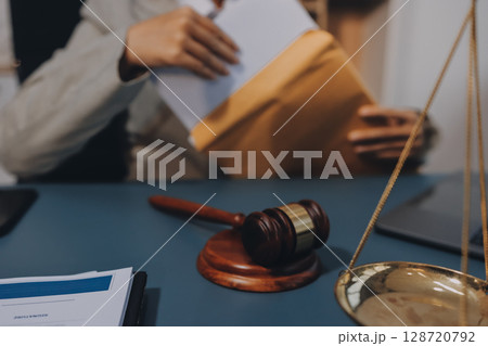 Judge gavel with Justice lawyers having team meeting at law firm background. Concepts of Law and Legal services. Judge gavel with Justice lawyers having team meeting at law firm background. Concepts of Law and Legal services. 128720792