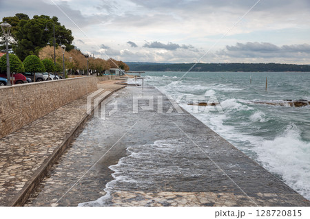 Storm waves crashing over stone pier in Novigrad, Croatia. Storm waves crashing over stone pier in Novigrad, Croatia. 128720815
