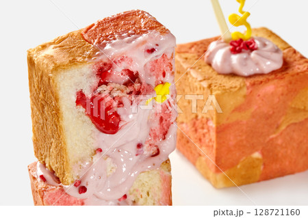 Delicious strawberry dessert displaying vibrant pink and white cream filling Delicious strawberry dessert displaying vibrant pink and white cream filling 128721160