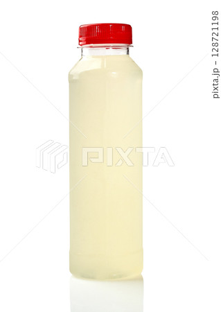 Plastic bottle of lemonade juice with red cap on white background reflecting 128721198