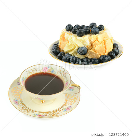 Coffee in porcelain vintage cup and meringue cake isolated on white background. 128721400