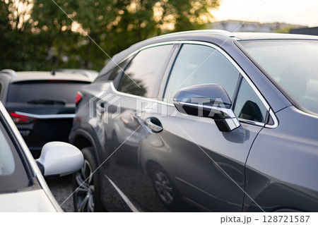 A row of cars parked outdoors, showcasing modern automotive design and urban transportation. 128721587