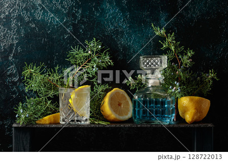 Cocktail gin-tonic with ice, lemon, and rosemary in a frozen glass. Cocktail gin-tonic with ice, lemon, and rosemary in a frozen glass. 128722013