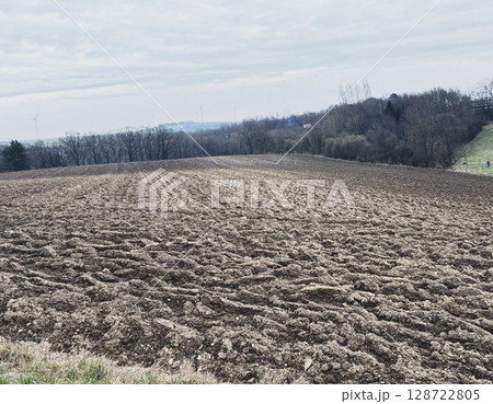Plowed field and a good weather 128722805