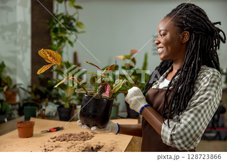 Young woman working in the flower shop and feeling good Young woman working in the flower shop and feeling good 128723866