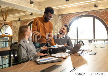 Coworkers discussing project details and looking interested 128723910