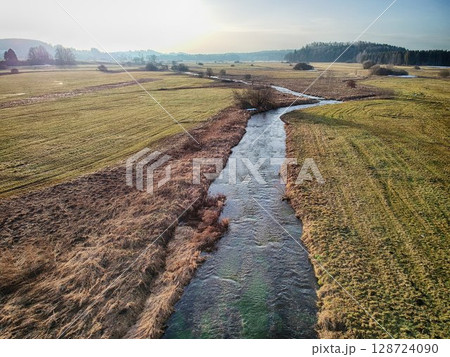 River runs through a field of grass River runs through a field of grass 128724090