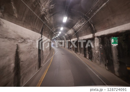 Tunnel with a road inside of it Tunnel with a road inside of it 128724091