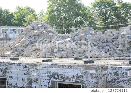 A pile of rubble sits on top of a building 128724111