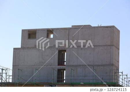 A large concrete building with a window on the side A large concrete building with a window on the side 128724115